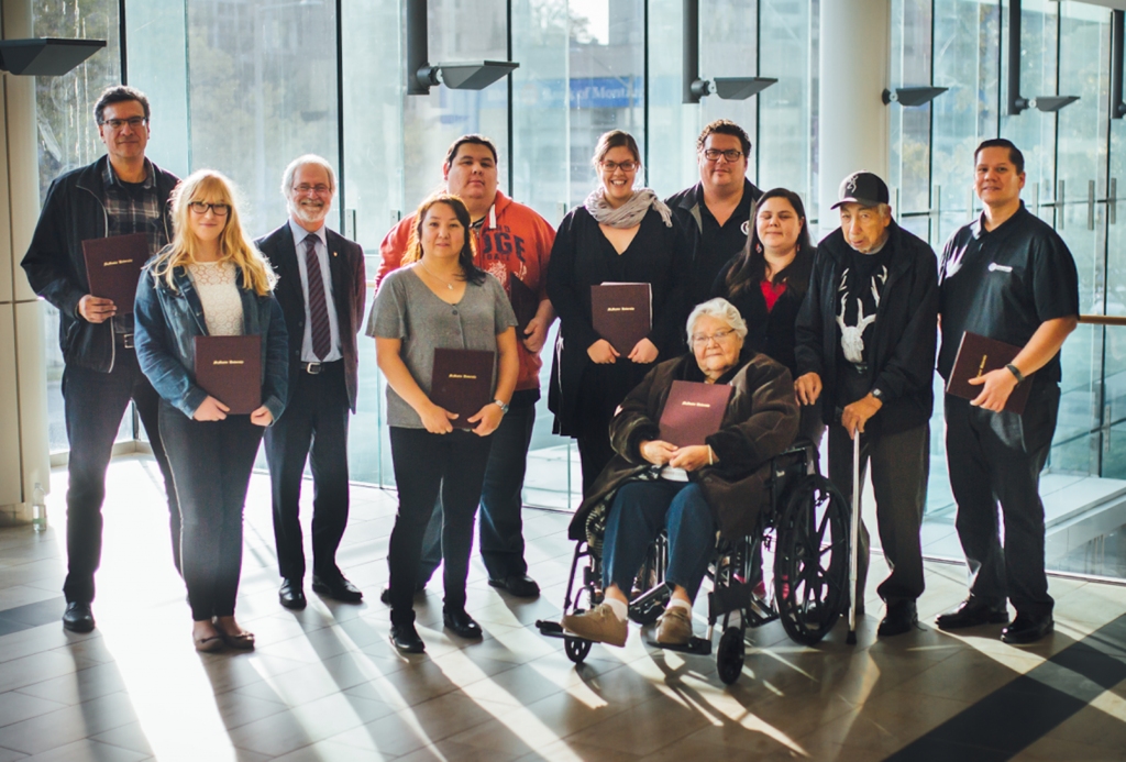 Grand River Mohawk President's Award winners pose for a photo together as a group with former President Patrick Deane, standing in rows.