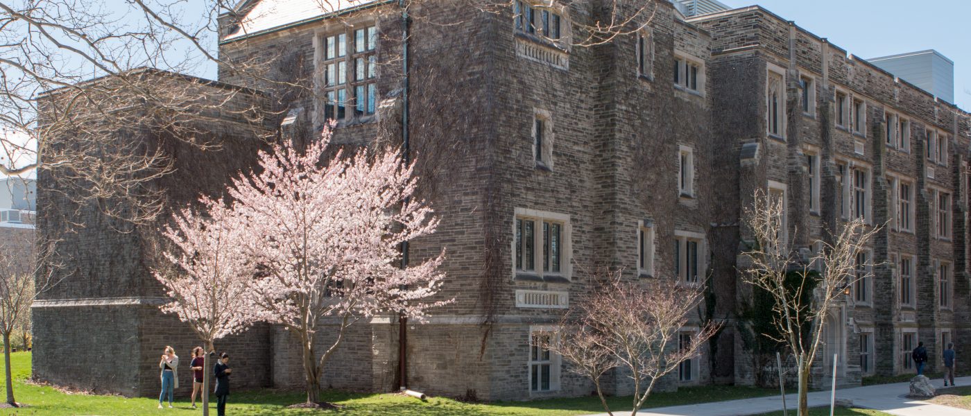 Hamilton Hall building in the spring, with cherry blossom tree blooming.